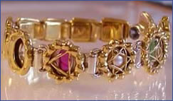 nine gem bangle in gold with chakra design